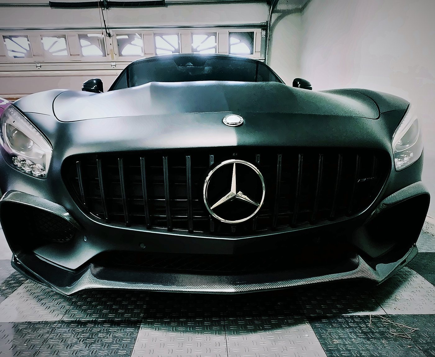 Front of Chad’s 2016 Mercedes-AMG GT S in stealth black with its Panamericana grille, chrome star and carbon fiber front lip