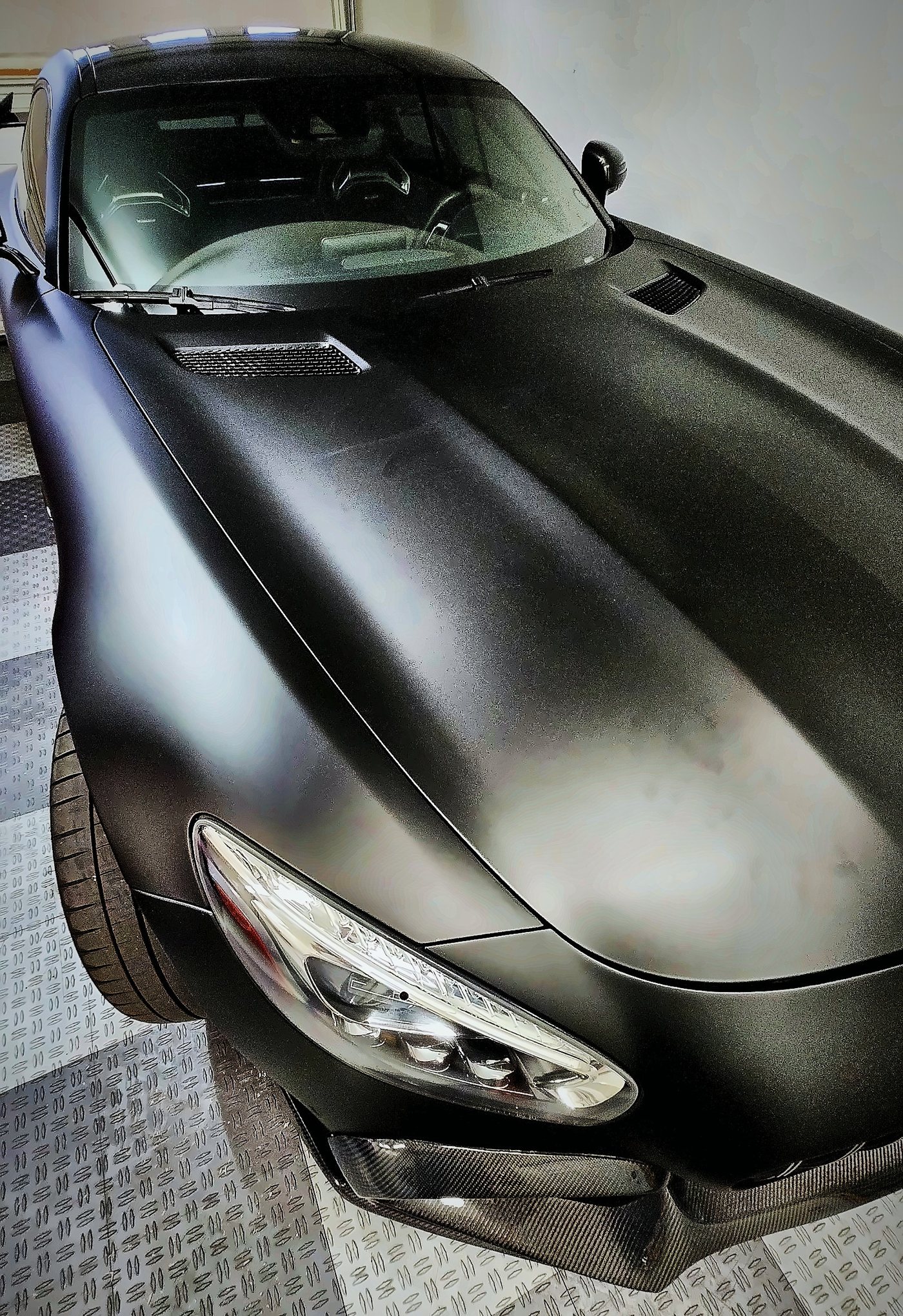 The AMG GT S long stealth black hood, hood vents and LED headlight from above