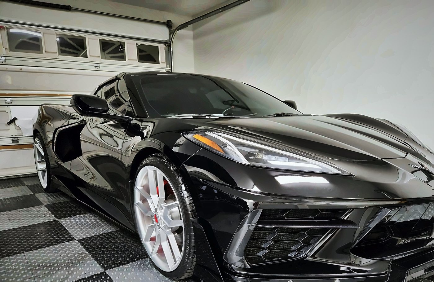 Front of the black Corvette Stingray showing the aero front splitter and LED headlights