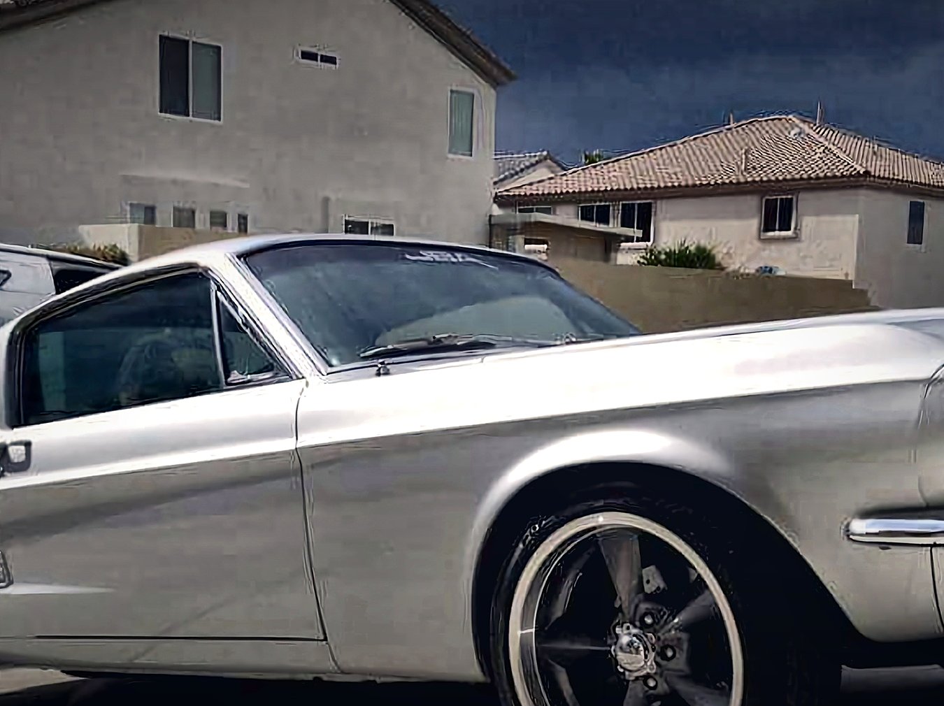 Front three-quarter view of the silver 1967 Mustang Fastback parked in a Las Vegas driveway